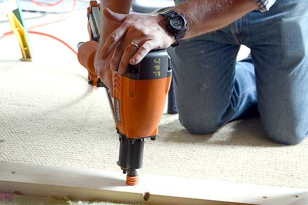 Contractor drilling into wood.