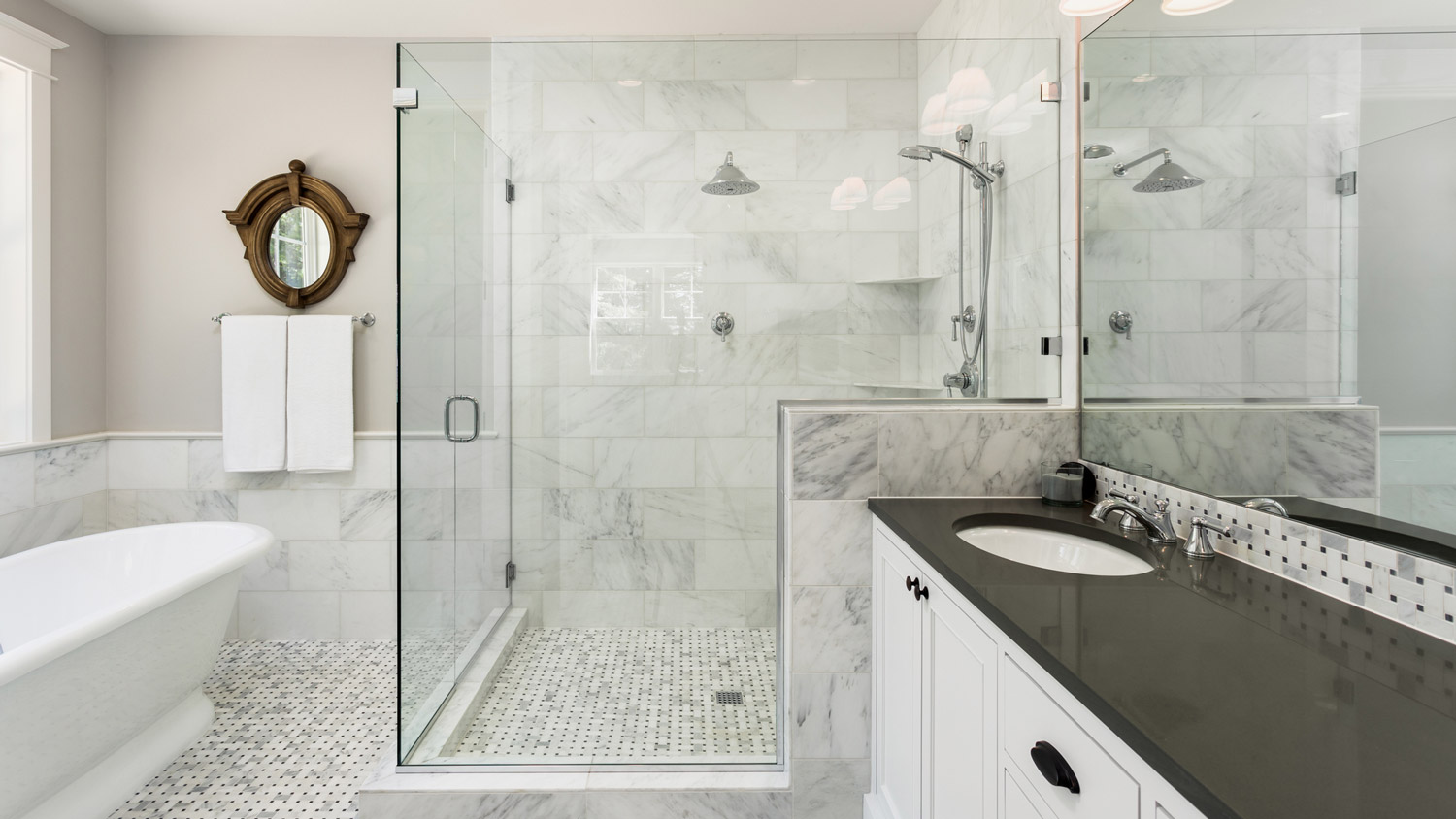 A glass shower cabin in a spacious bathroom