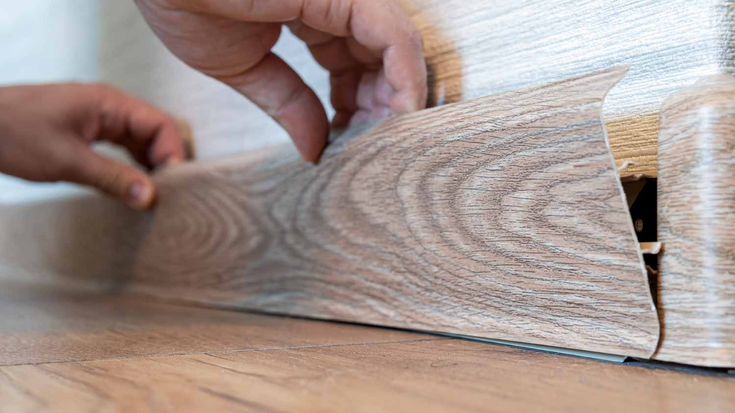 Man replacing baseboards