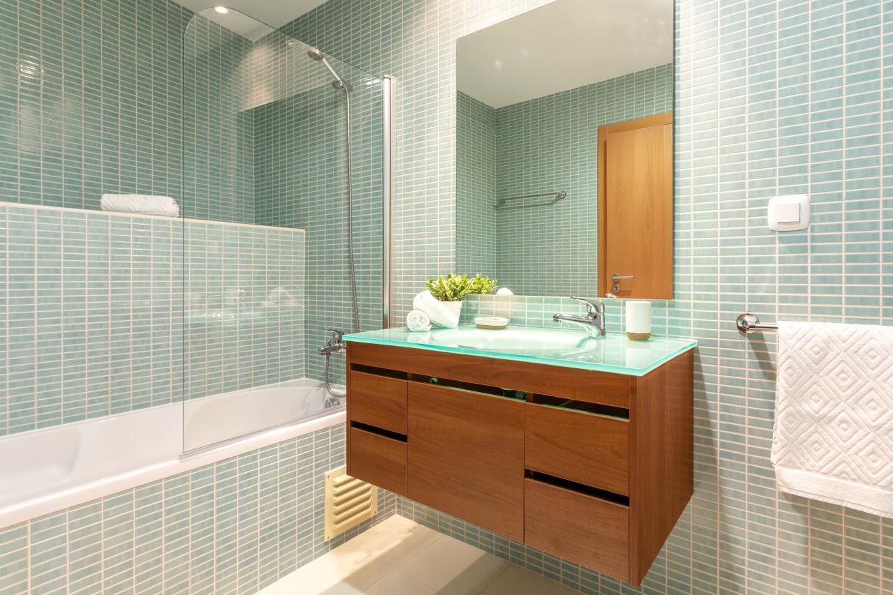A modern bathroom with shower and washbasin
