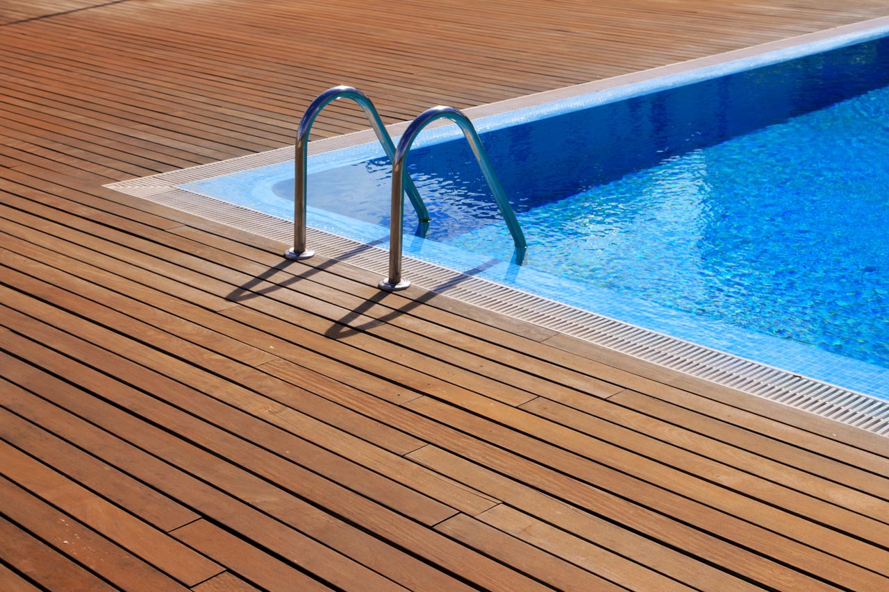 new wooden deck built around swimming pool