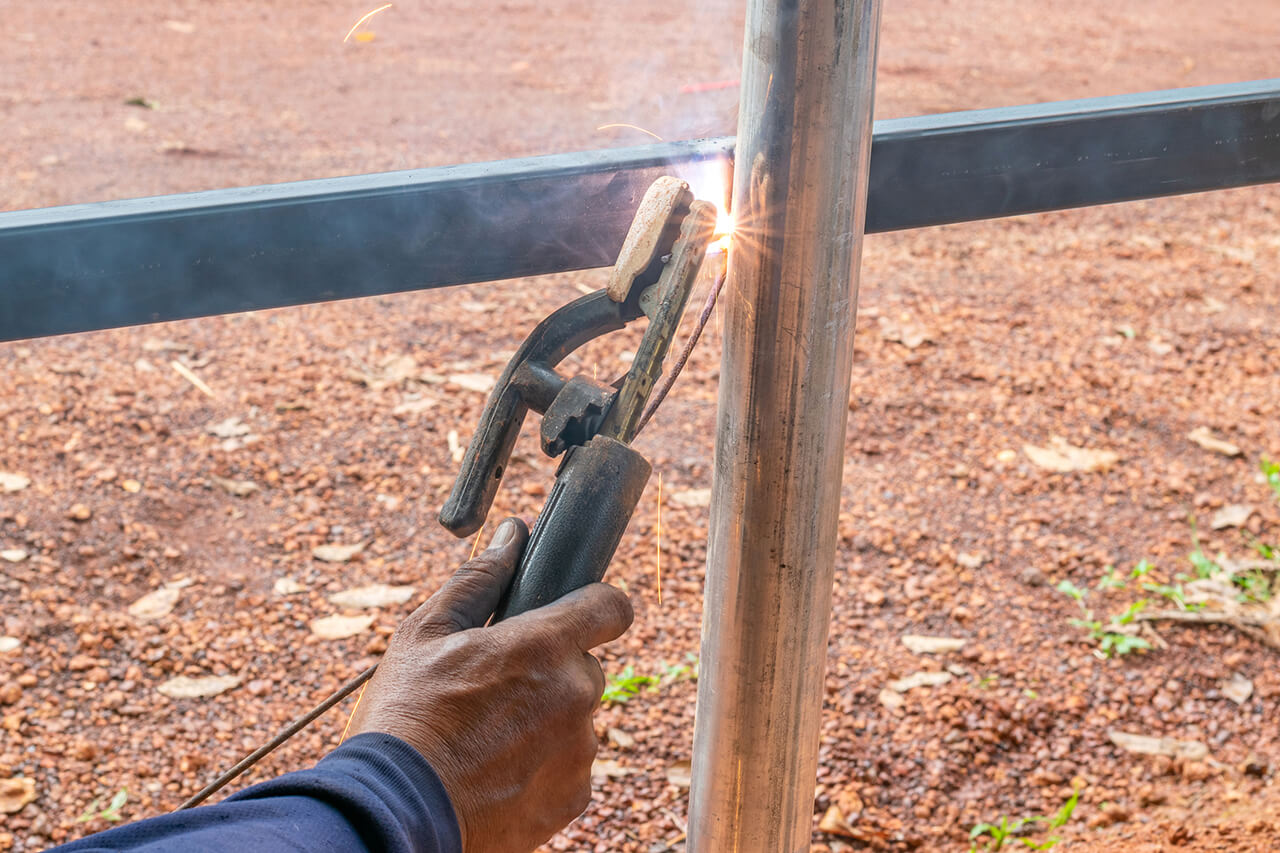 aluminum fence being welded during a repair